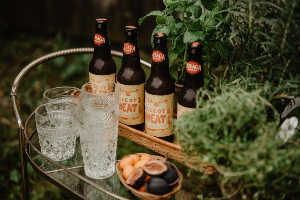 Cozy outdoor scene with beer bottles and fresh herbs on a bar cart.